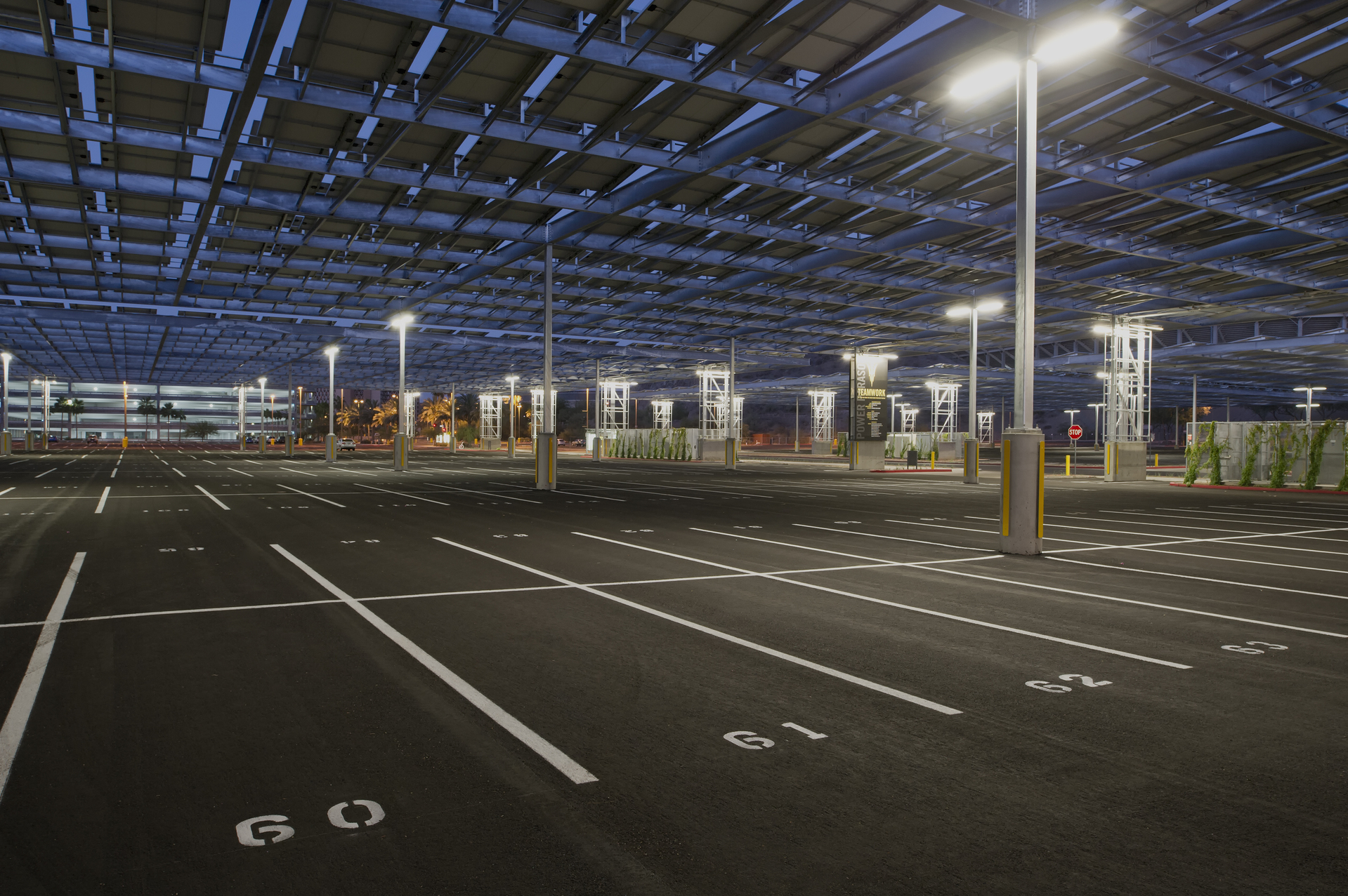 The minutes before sunrise cast a blue hue through the four PowerParasol solar structures at Arizona State's Lot 59. Over five acres of parking lot is now protected from the harsh Arizona sun and provides a venue for tailgating and large events. Original public domain image from Flickr